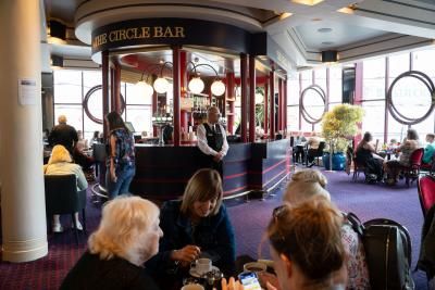 An image of a group of people sat at tables in the Dress Circle Cafe
